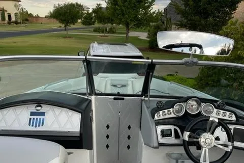Slide: The Image of 2015 MasterCraft X-55 boat interior with steering wheel and dashboard view. - 2
