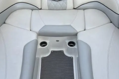 Slide: The Image of 2015 MasterCraft X-55 boat interior with cushioned seating and cup holders. - 4