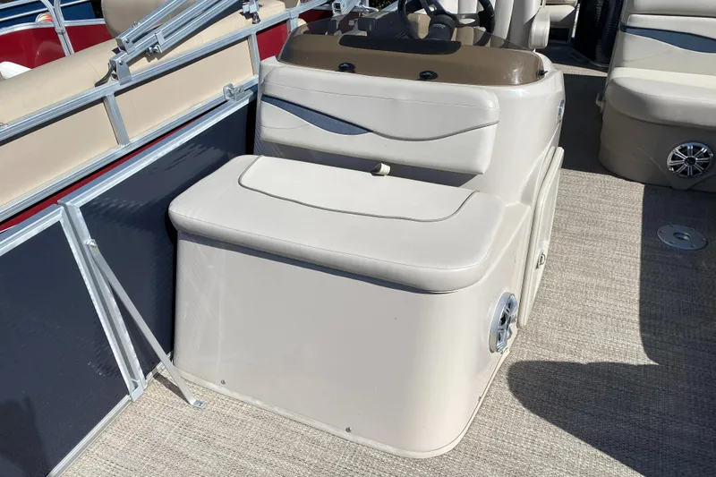 Slide: The Image of 2018 Bennington 22 SFX boat seating area with beige upholstery and storage compartment. - 10