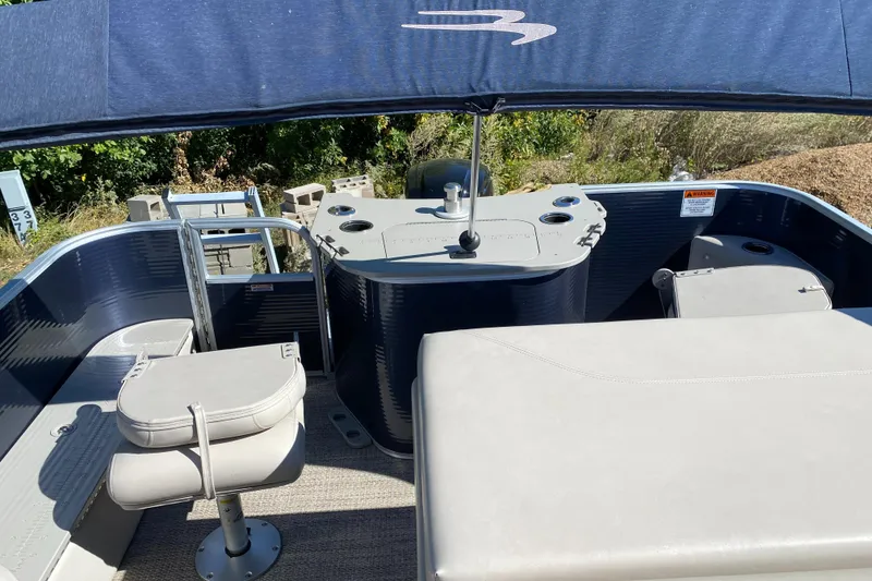 Slide: The Image of 2018 Bennington 22 SFX boat interior with seating and helm under canopy. - 12