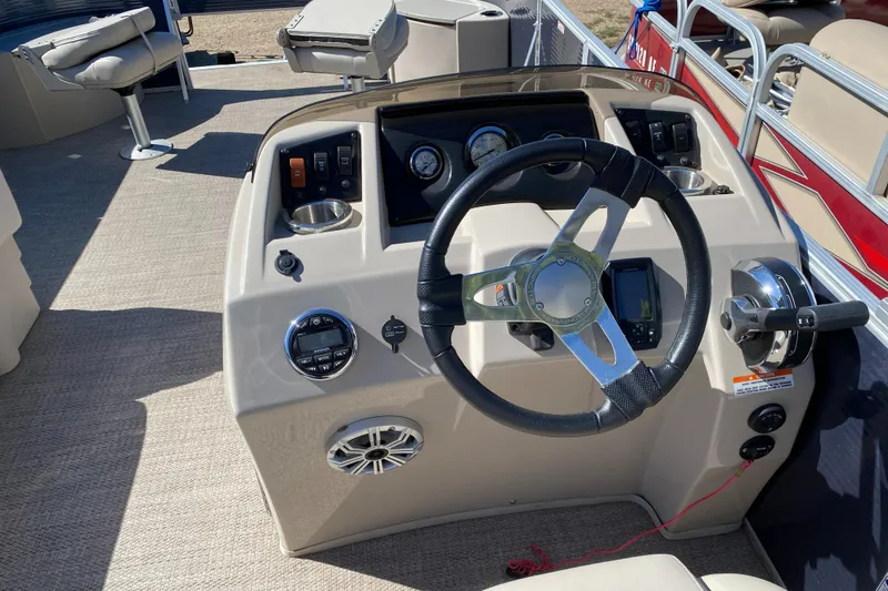Slide: The Image of 2018 Bennington 22 SFX boat dashboard with steering wheel and controls. - 13