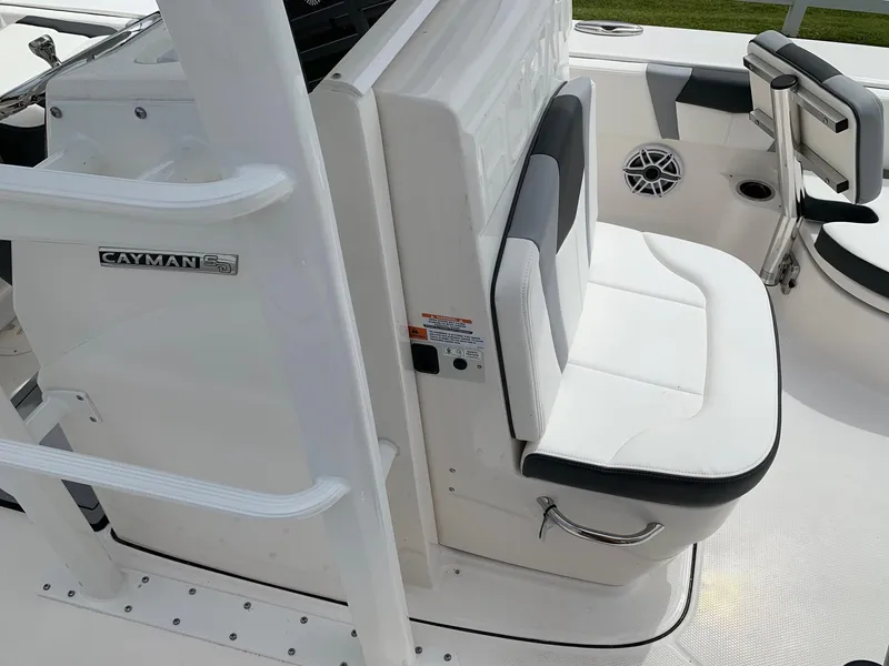 Slide: The Image of 2026 Robalo 246 Cayman Sky Deck boat interior with white seating and sleek design. - 12