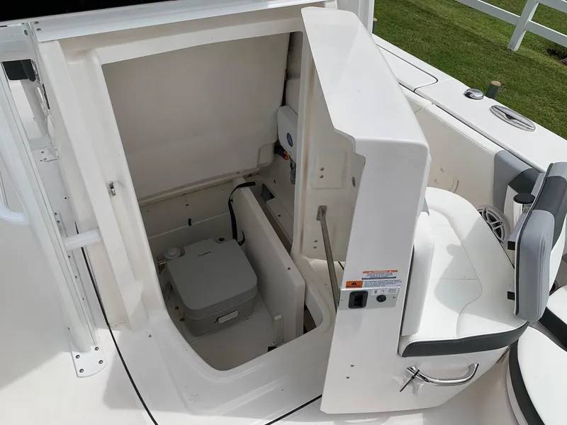 Slide: The Image of 2026 Robalo 246 Cayman Sky Deck boat interior storage compartment with seating. - 11