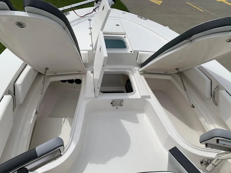Slide: The Image of 2026 Robalo 246 Cayman Sky Deck boat storage compartments open on deck. - 13