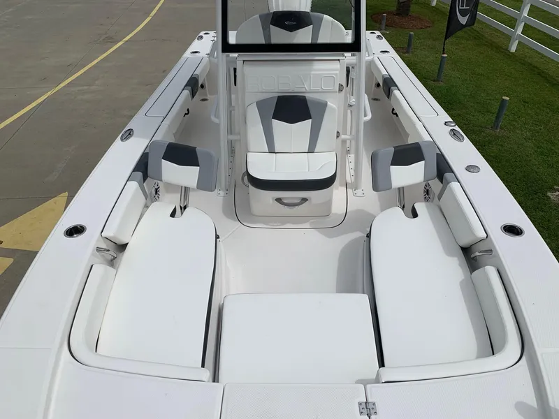 Slide: The Image of 2026 Robalo 246 Cayman Sky Deck boat interior with white seating and modern design. - 14