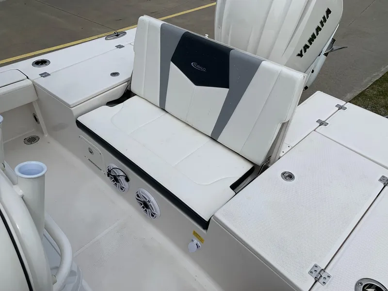 Slide: The Image of 2026 Robalo 246 Cayman Sky Deck boat seating area with Yamaha engine. - 6