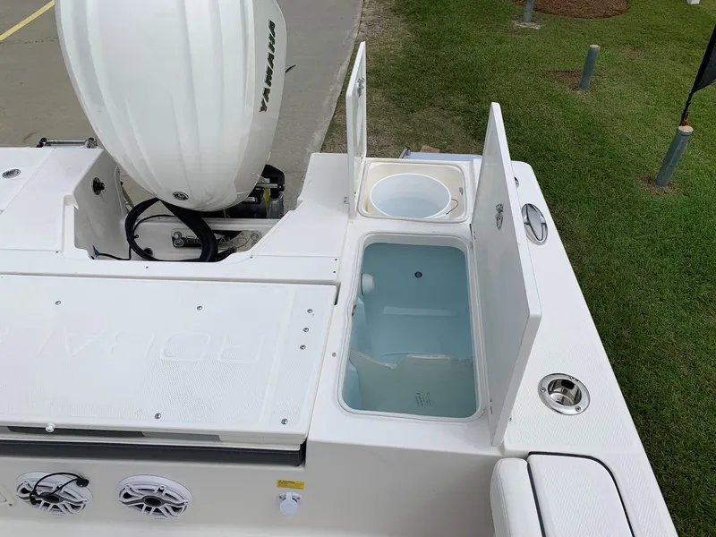 Slide: The Image of 2026 Robalo 246 Cayman Sky Deck boat with open storage compartments. - 7