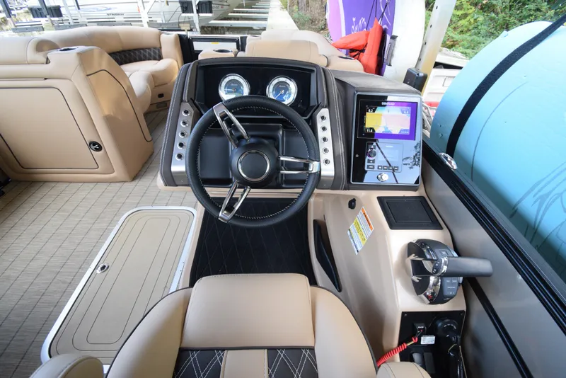 Slide: The Image of 2022 Barletta Lusso 23UC boat interior with steering wheel and control panel. - 28