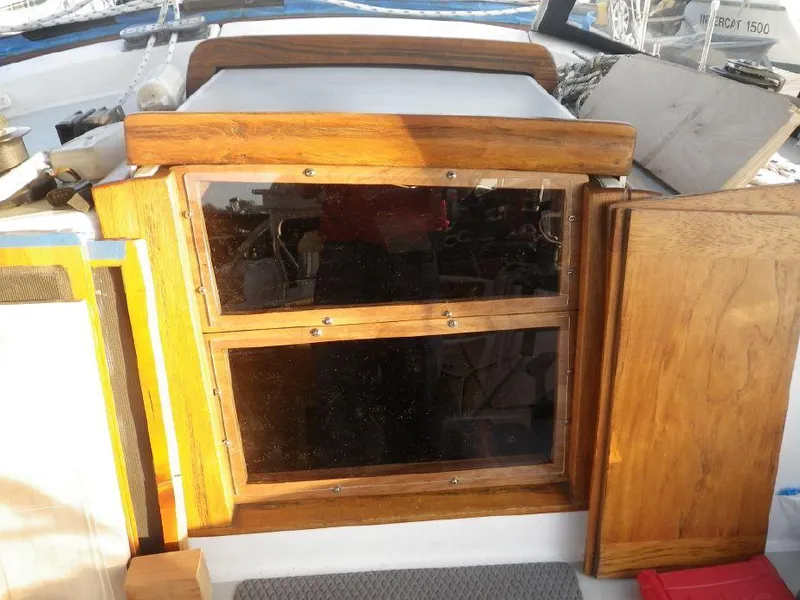Slide: The Image of 1981 Southern Cross 39' yacht cabin entrance with wooden doors and windows. - 13