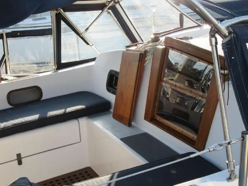 Slide: The Image of 1981 Southern Cross 39' yacht interior with wooden accents and cushioned seating. - 14