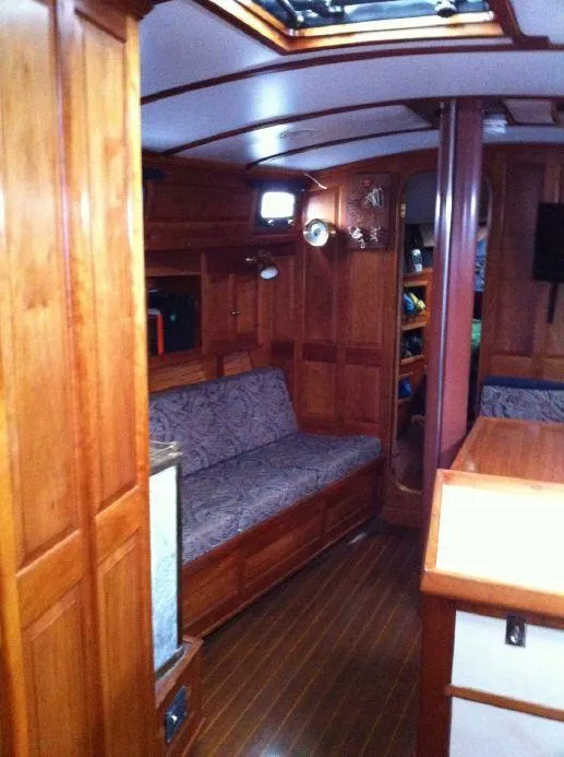 Slide: The Image of Interior of 1981 Southern Cross 39' yacht with wooden furnishings and cozy seating area. - 15