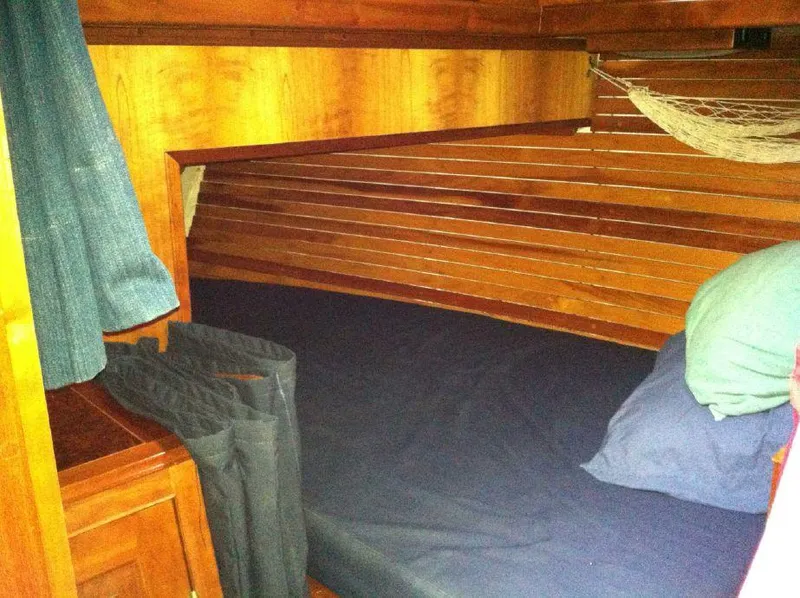 Slide: The Image of Cozy wooden cabin interior of 1981 Southern Cross 39' sailboat with bed and storage. - 26
