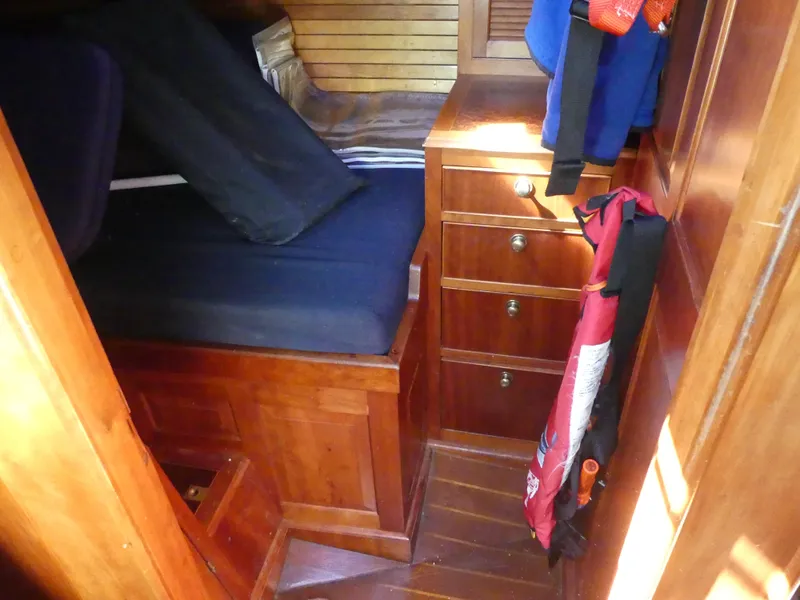 Slide: The Image of Interior cabin of 1981 Southern Cross 39' sailboat with wooden furniture and storage. - 29