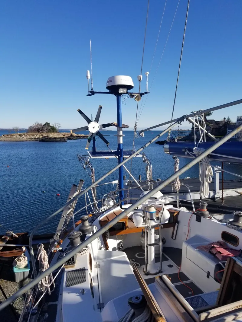 Slide: The Image of 1981 Southern Cross 39' sailboat docked by serene waters under clear blue sky. - 39