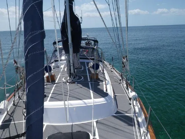 Slide: The Image of 1981 Southern Cross 39' sailboat on calm ocean waters, showcasing deck and rigging. - 5