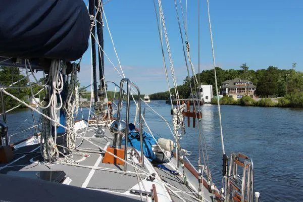 Slide: The Image of Sailing on a 1981 Southern Cross 39' yacht in a serene river setting. - 6