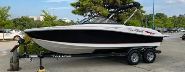 The Image of 2023 Tahoe 210 Si boat on trailer in outdoor setting. - 0