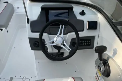Slide: The Image of 2023 Tahoe 210 Si boat dashboard with steering wheel and control panel. - 3