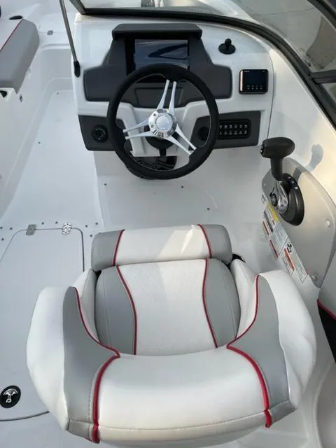 Slide: The Image of 2023 Tahoe 210 Si boat cockpit with steering wheel and captain's chair. - 4