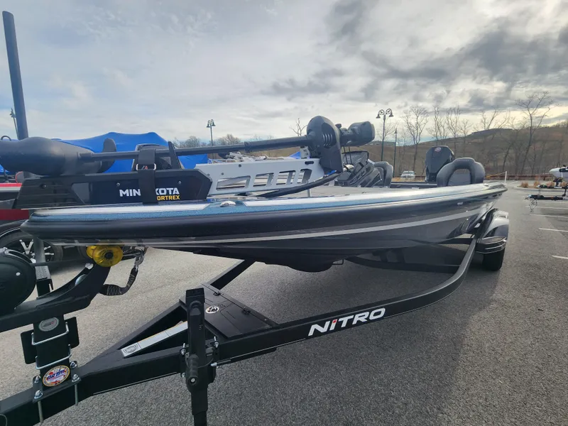 Slide: The Image of 2023 Nitro Z21 XL fishing boat on trailer, parked outdoors. - 1