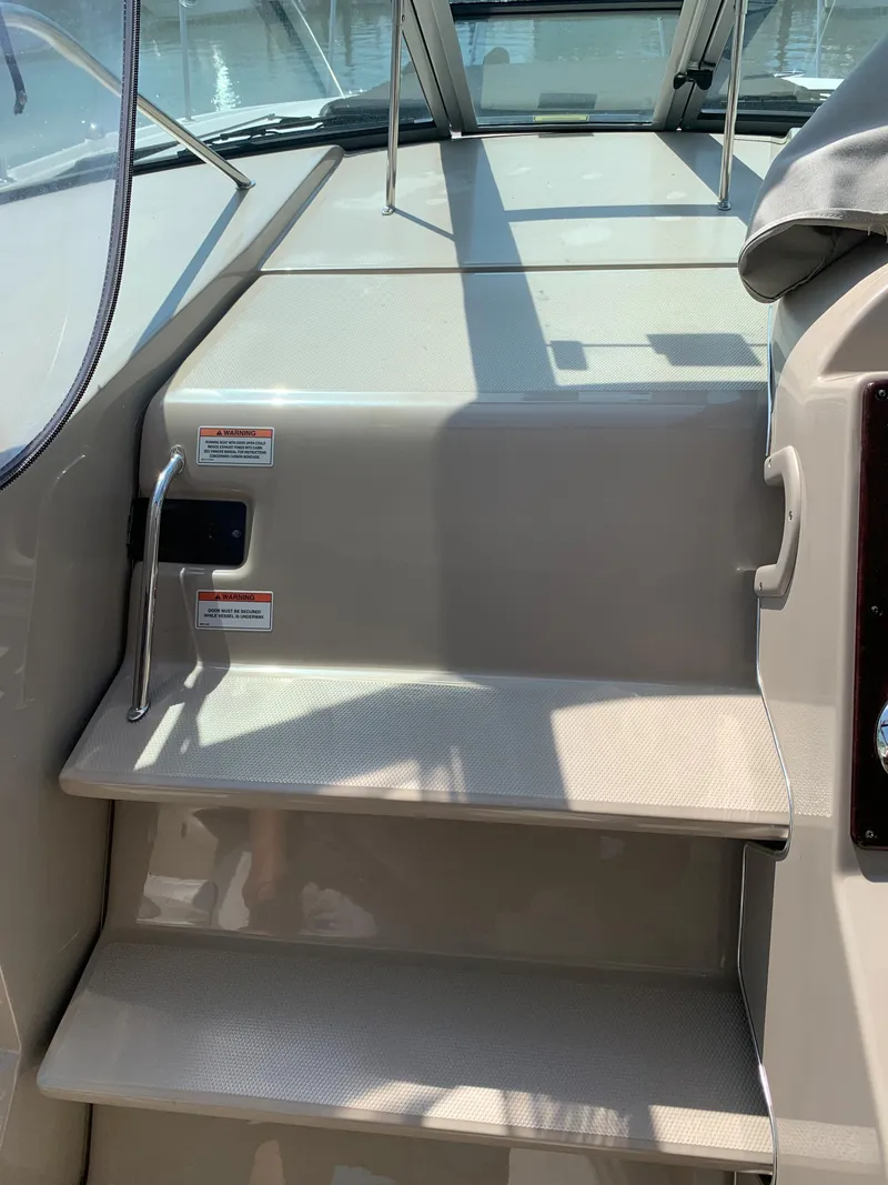 Slide: The Image of 2008 Sea Ray 330 Sundancer boat steps with handrails and non-slip surface. - 11