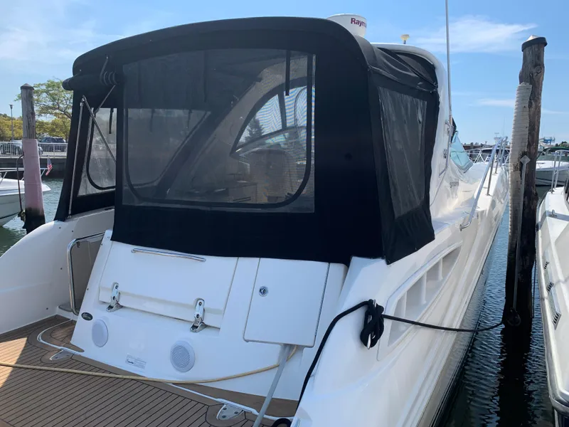 Slide: The Image of 2008 Sea Ray 330 Sundancer docked with black canvas cover. - 2