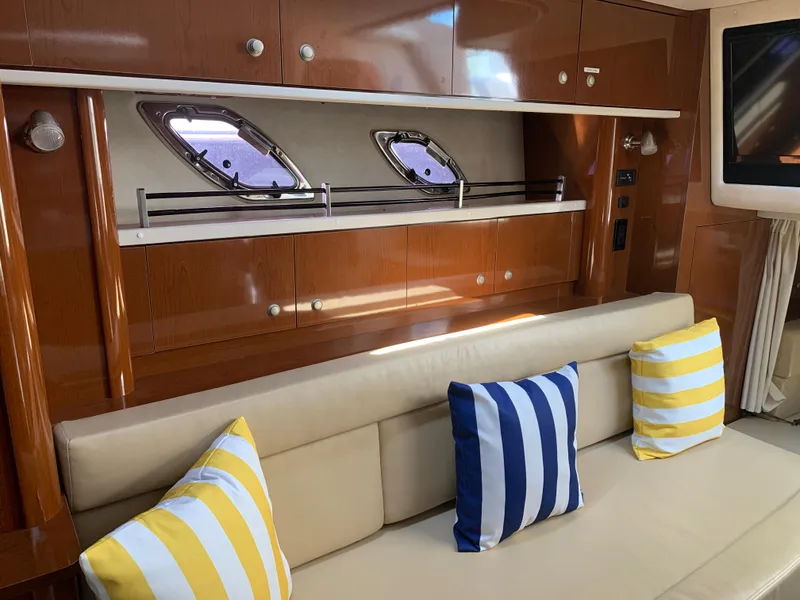 Slide: The Image of Interior of 2008 Sea Ray 330 Sundancer with striped cushions and wooden cabinetry. - 22