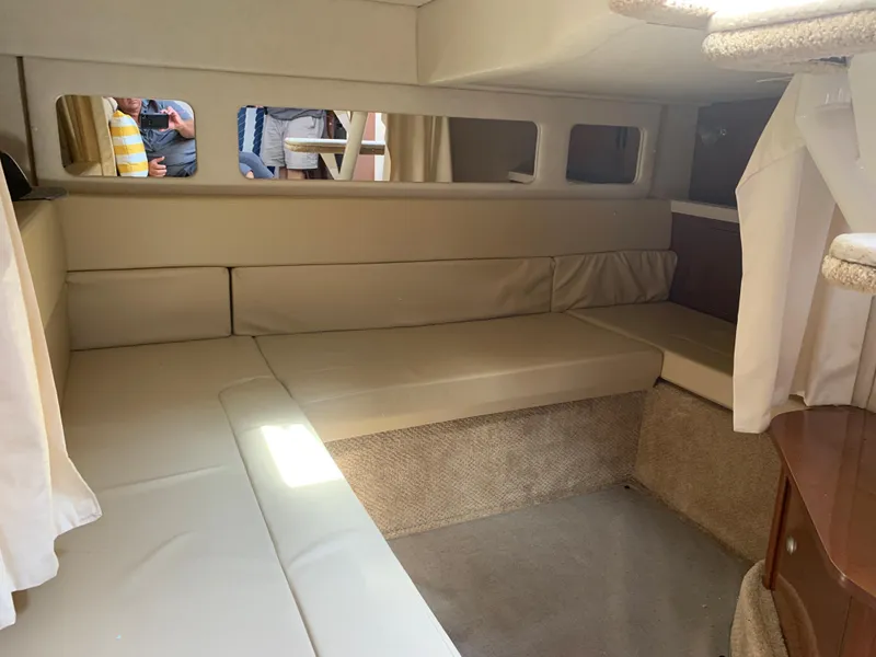 Slide: The Image of 2008 Sea Ray 330 Sundancer cabin interior with beige seating and carpet. - 25