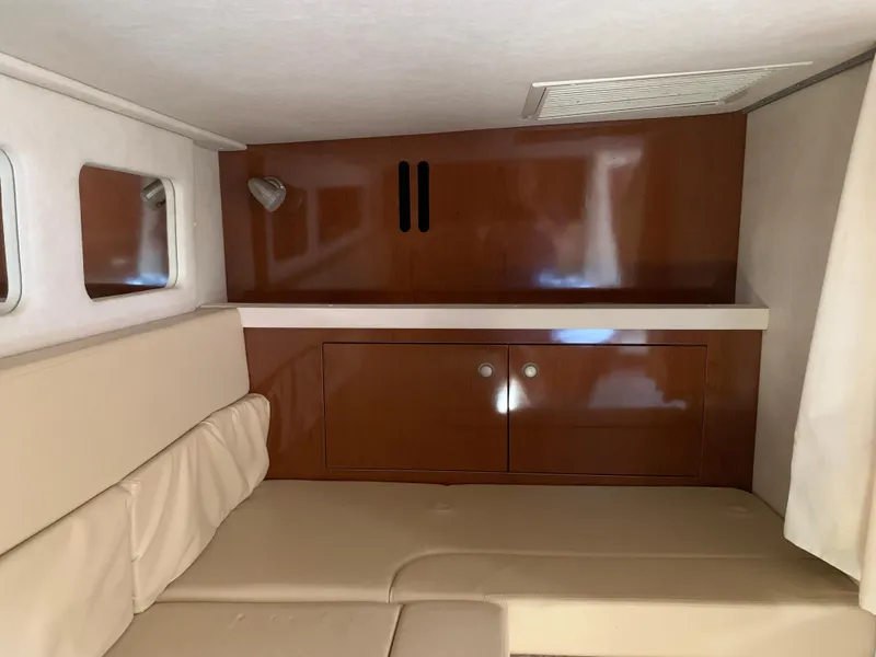 Slide: The Image of Interior cabin of 2008 Sea Ray 330 Sundancer with beige seating and wooden cabinetry. - 27