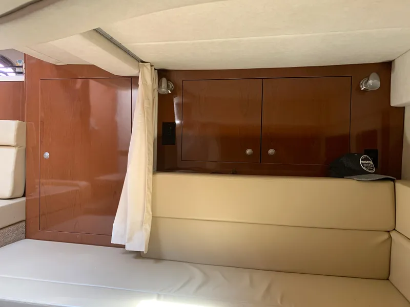 Slide: The Image of Interior cabin of 2008 Sea Ray 330 Sundancer with beige seating and wooden cabinetry. - 28