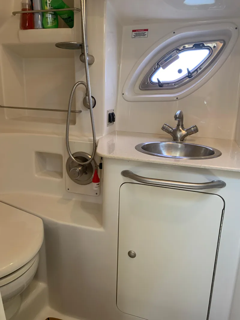 Slide: The Image of 2008 Sea Ray 330 Sundancer bathroom with sink, shower, and porthole window. - 29