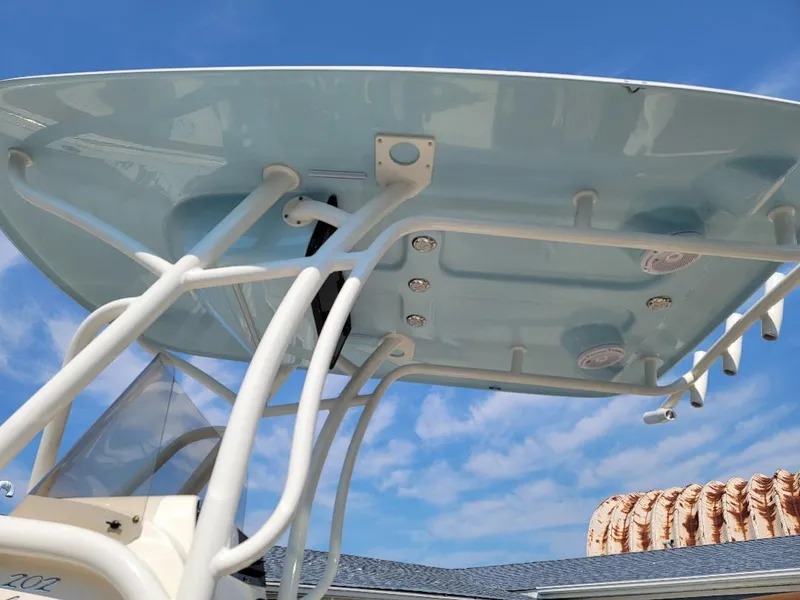 Slide: The Image of 2023 Pioneer 202 Islander boat T-top against blue sky. - 4