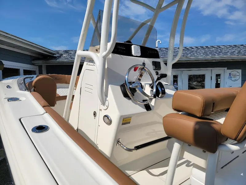 Slide: The Image of 2023 Pioneer 202 Islander boat interior with tan seating and steering wheel. - 5