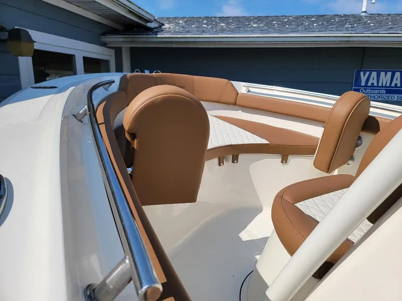 Slide: The Image of 2023 Pioneer 202 Islander boat interior with tan and white seating. - 6