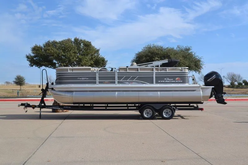 The Image of 2023 Sun Tracker Party Barge 22 RF XP3 pontoon boat on trailer, parked outdoors. - 0