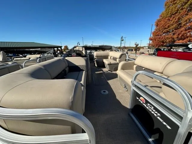 Slide: The Image of 2023 Sun Tracker Party Barge 22 RF XP3 interior with beige seating and helm. - 2
