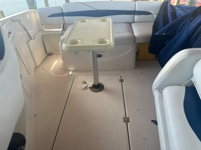 Slide: The Image of Interior of a 2003 Chaparral 215 SS Cuddy boat with seating and table. - 11