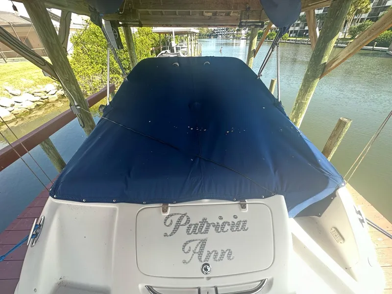 Slide: The Image of 2003 Chaparral 215 SS Cuddy boat docked with blue cover. - 2