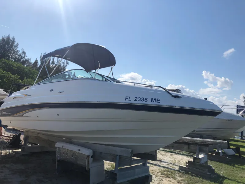 Slide: The Image of 2003 Chaparral 215 SS Cuddy boat on display under clear blue sky. - 6
