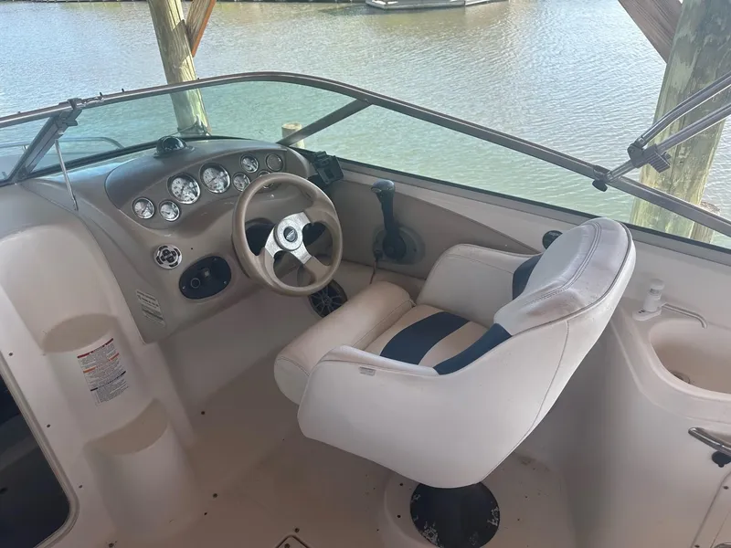 Slide: The Image of 2003 Chaparral 215 SS Cuddy boat cockpit with steering wheel and captain's chair. - 8