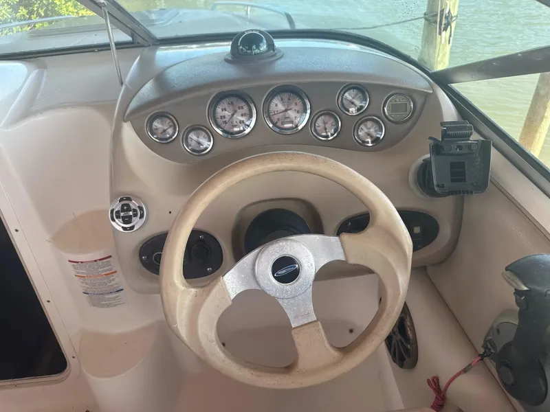 Slide: The Image of 2003 Chaparral 215 SS Cuddy boat dashboard with steering wheel and gauges. - 9
