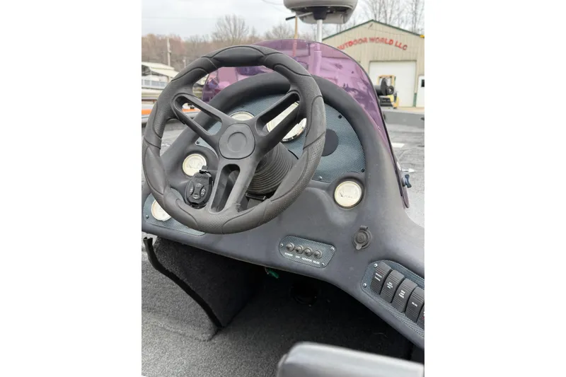 Slide: The Image of 2022 SeaArk Stealth 210 boat dashboard with steering wheel and control panel. - 11