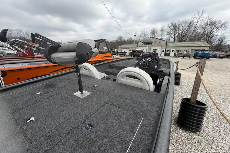 Slide: The Image of 2022 SeaArk Stealth 210 boat with seating and steering wheel, displayed outdoors. - 5