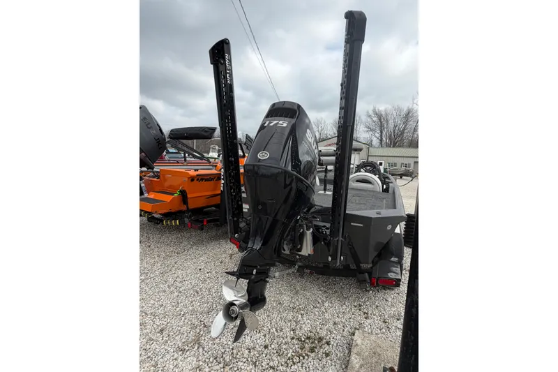 Slide: The Image of 2022 SeaArk Stealth 210 boat with powerful outboard motor, displayed outdoors. - 8