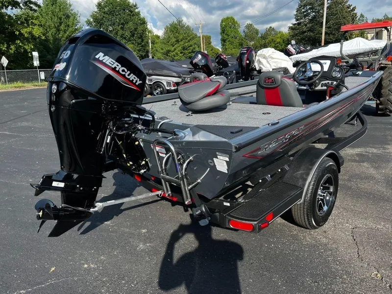 Slide: The Image of 2023 Ranger RT178 boat with Mercury engine, parked outdoors on a sunny day. - 11