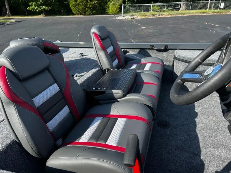 Slide: The Image of 2023 Ranger RT178 boat interior with gray and red seats, steering wheel, and carpeted floor. - 7