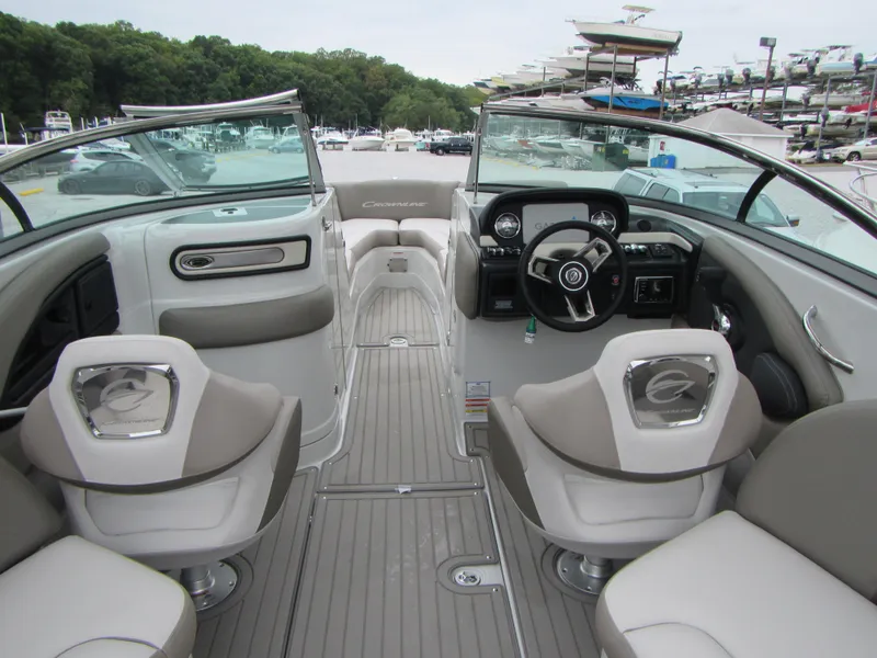 Slide: The Image of 2023 Crownline 270 SS boat interior with modern seating and steering wheel. - 12