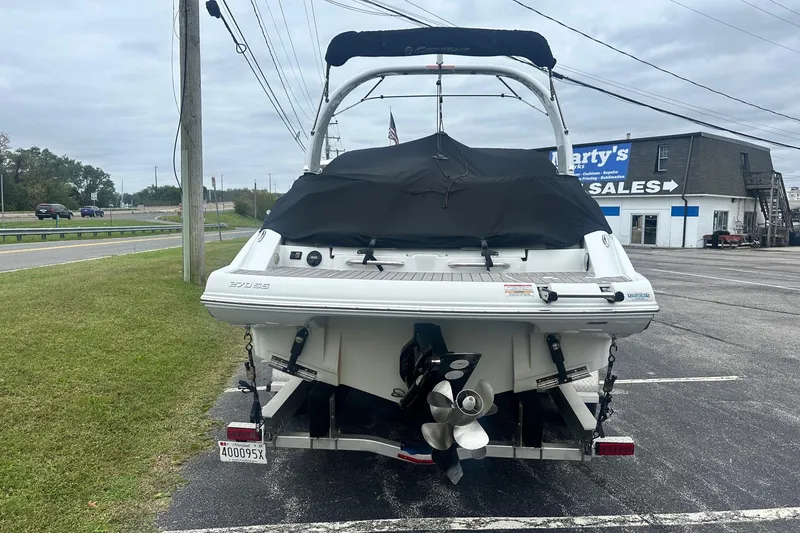 Slide: The Image of 2023 Crownline 270 SS boat, rear view, parked on a trailer near a sales building. - 2