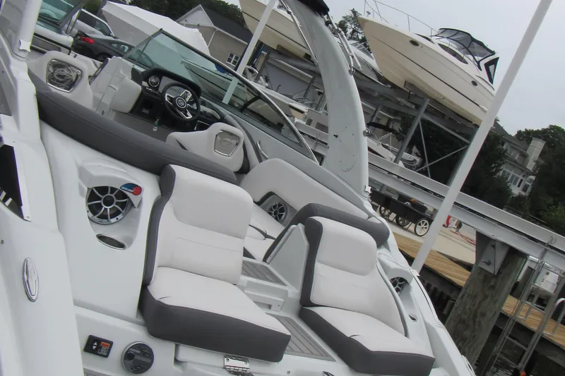 Slide: The Image of 2023 Crownline 270 SS boat interior with plush seating and modern dashboard. - 20