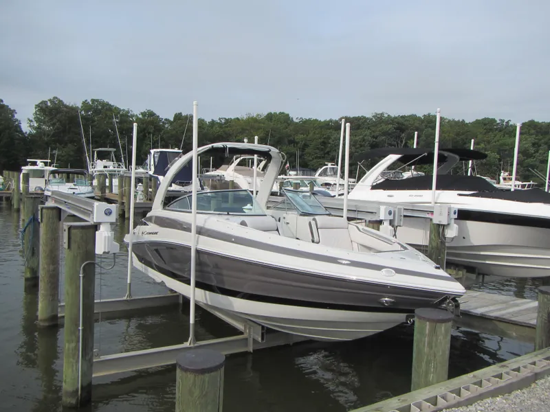 Slide: The Image of 2023 Crownline 270 SS boat docked at a marina, surrounded by other boats. - 3